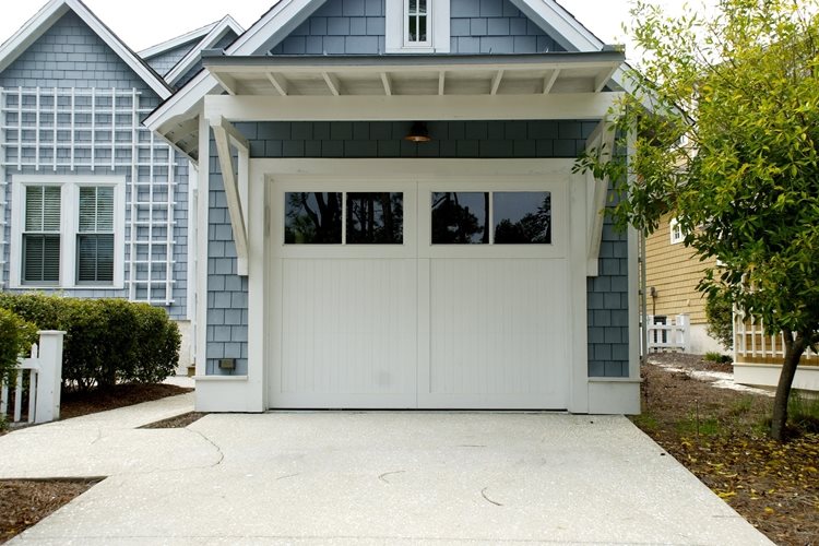 House with light blue siding and white one-car garage door