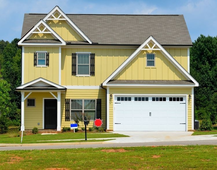 garage door with windows on a yellow house with white trim