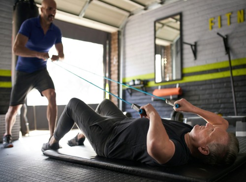 Two men lifting weights in garage workout space