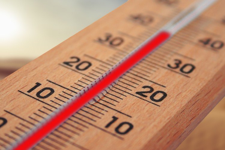 Close-up of outdoor mercury thermometer showing temperature of 35 degrees