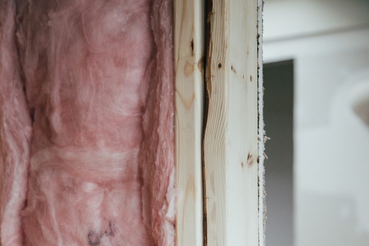 Pink insulation inside interior wall of developing home