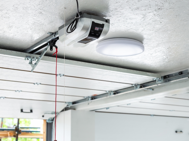 Garage door opener on ceiling of open garage