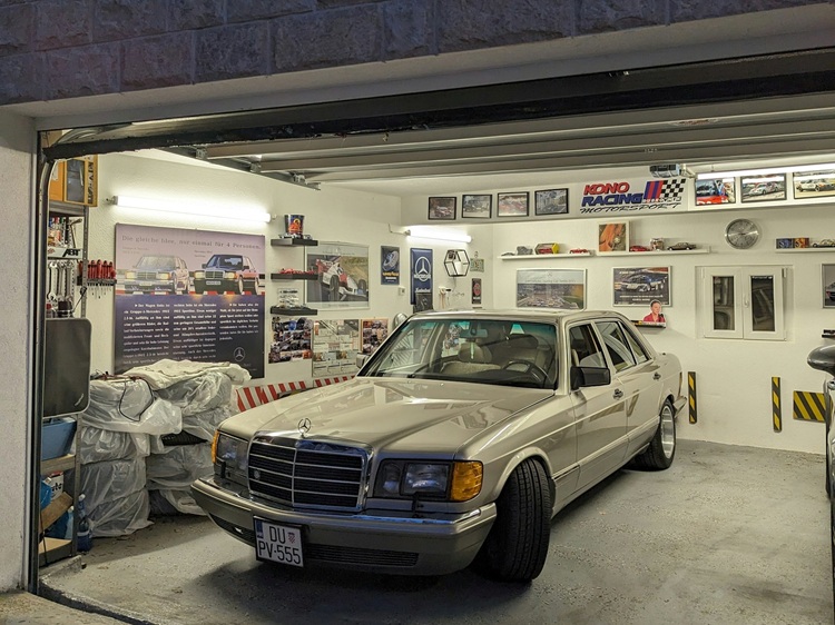 Two-car garage stuck open with beige sedan inside