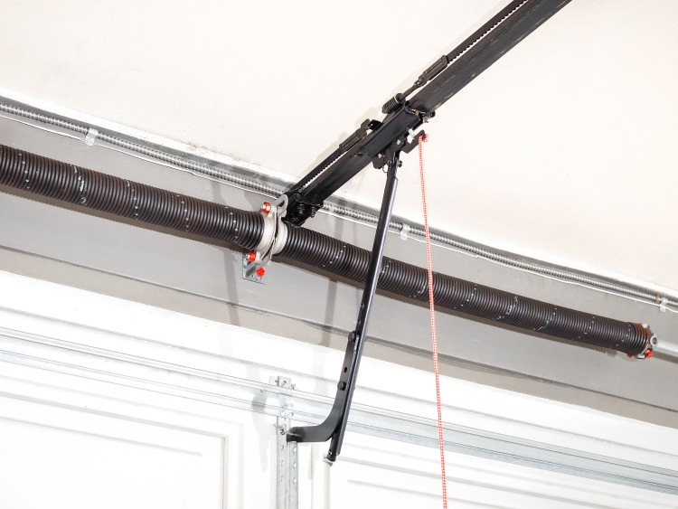 Torsion springs and cable along top of residential garage door