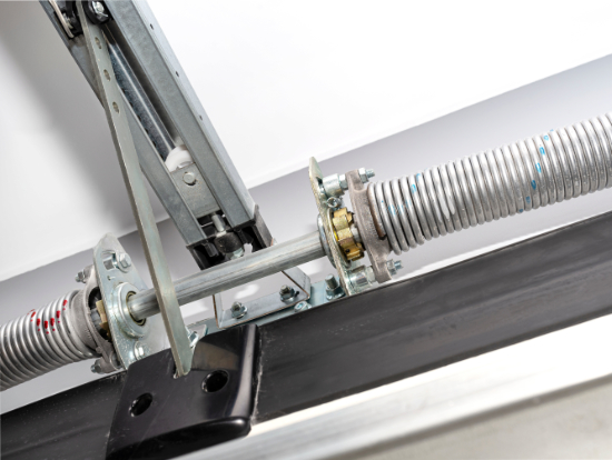Close-up of a torsion spring assembly above a garage door
