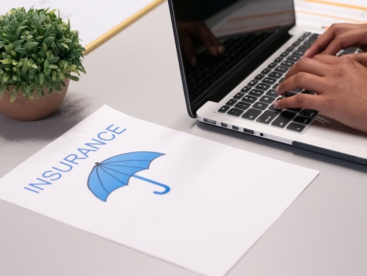 white paper with umbrella and the word insurance